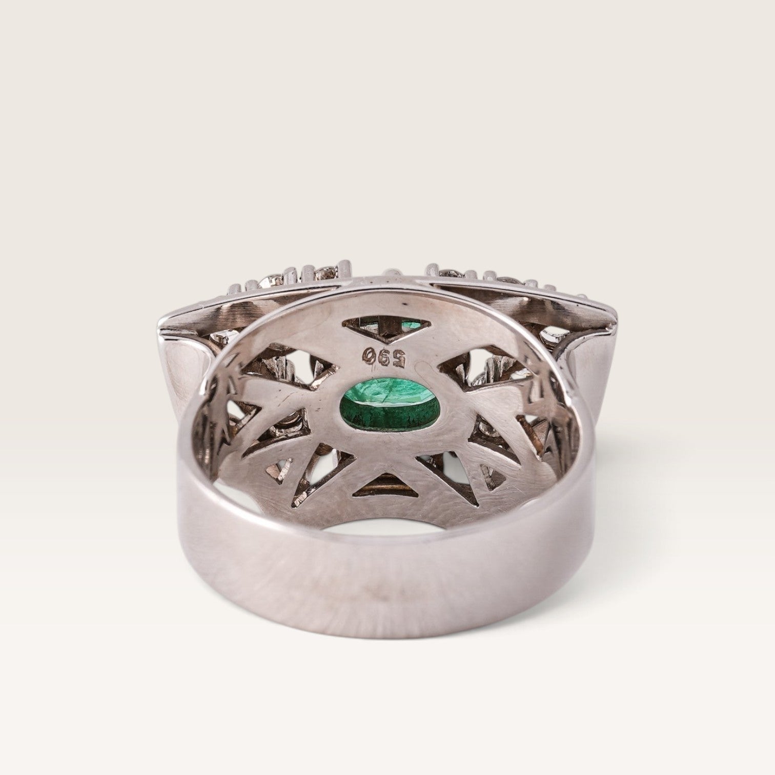 Menina Amsterdam Veyla 14K gold statement ring featuring a central emerald and diamond geometric setting, back view.
